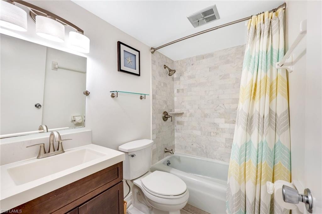 Full bathroom featuring shower / bath combo with shower curtain and vanity