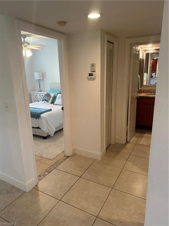 to the left of the entry Hallway with the guest bathroom and tile patterned floors