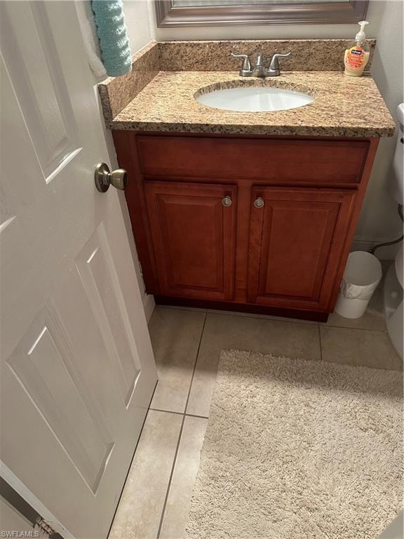 Bathroom featuring tile patterned floors, vanity, and toilet