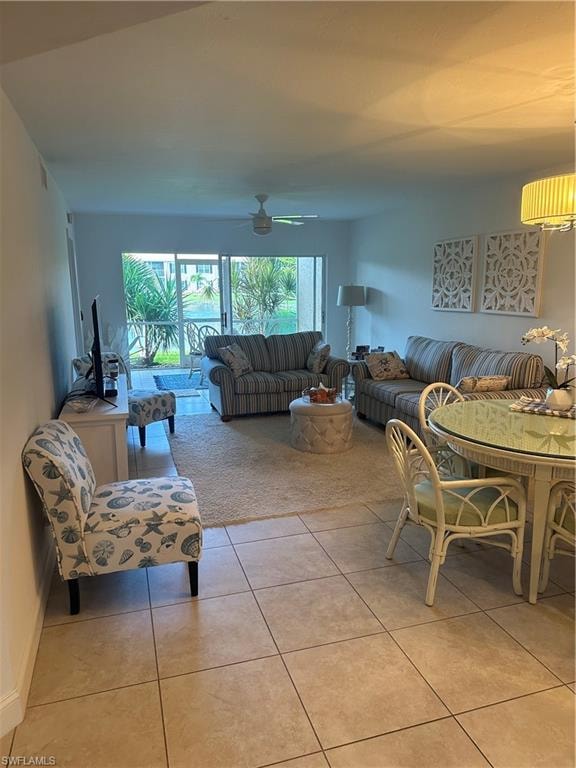 Tiled living room featuring ceiling fan