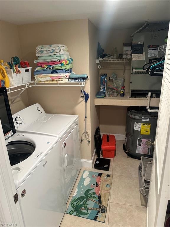 Laundry area with light tile patterned flooring and washer and clothes dryer