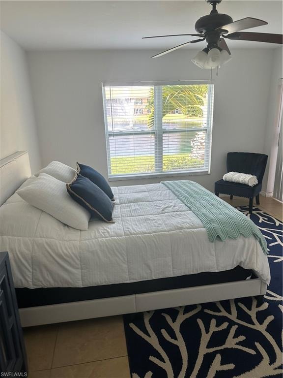 Bedroom featuring ceiling fan and tile patterned flooring