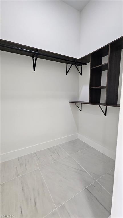 Walk in closet featuring light tile patterned floors