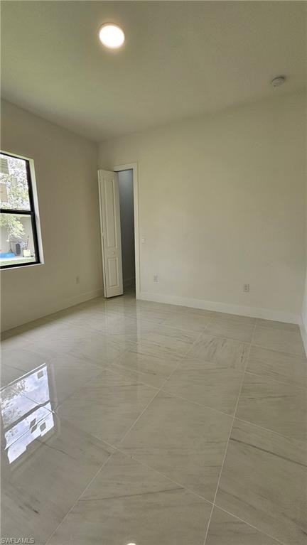 Unfurnished room with recessed lighting and light tile patterned floors