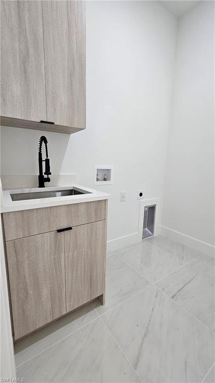 Laundry area featuring hookup for an electric dryer, cabinet space, and hookup for a washing machine