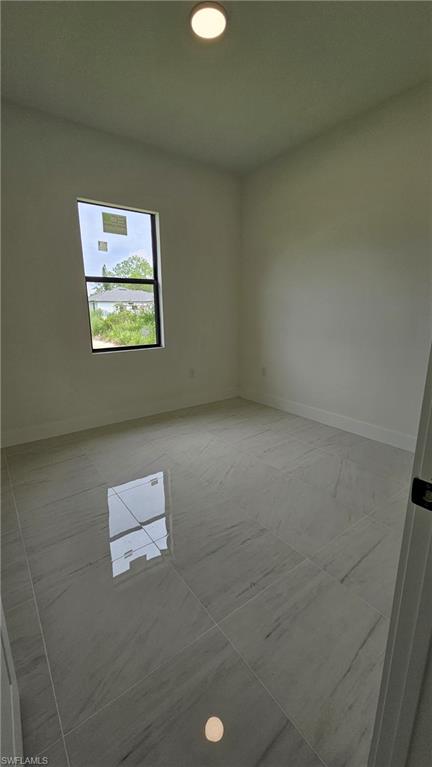 Unfurnished room featuring baseboards and recessed lighting