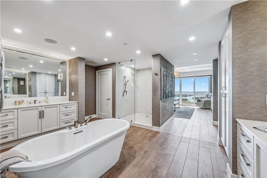 Master Bathroom featuring a shower stall, vanity, and a freestanding bath