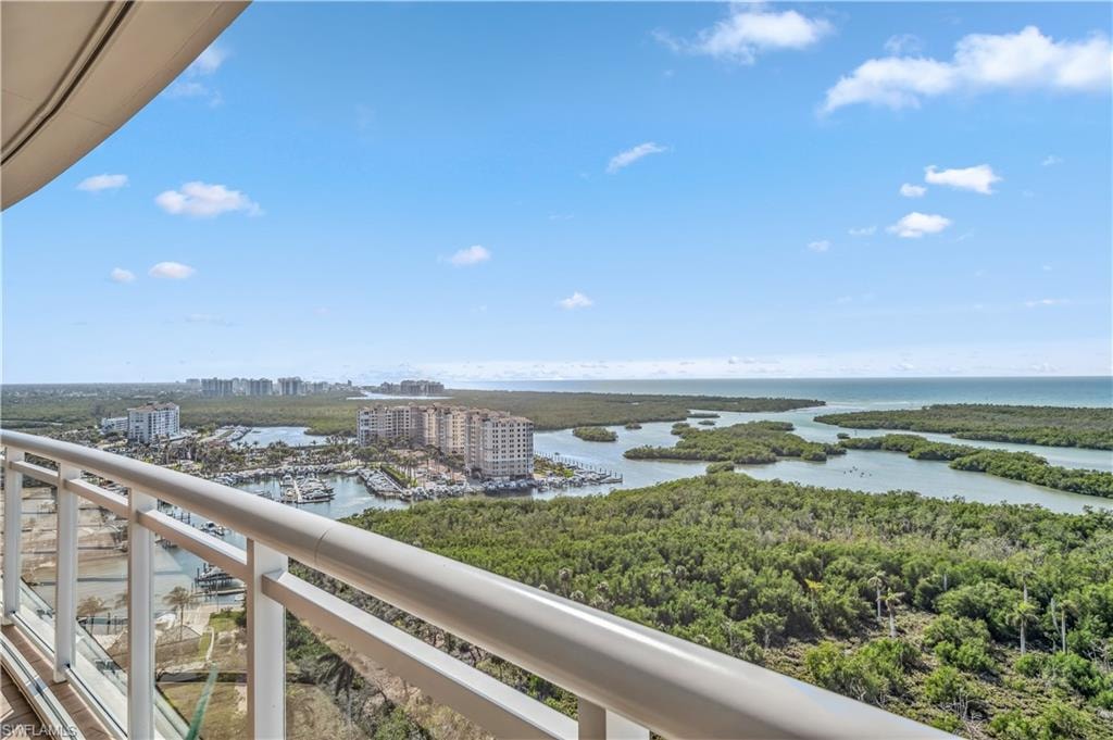 Water view featuring nearby urban area, bay, and a marina