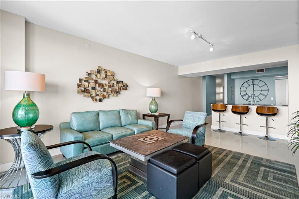 Living area featuring tile patterned floors and rail lighting