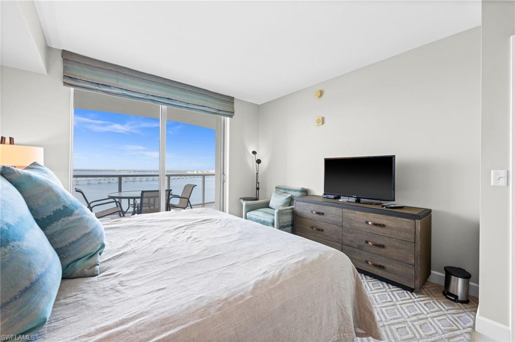 Bedroom featuring access to exterior and floor to ceiling windows