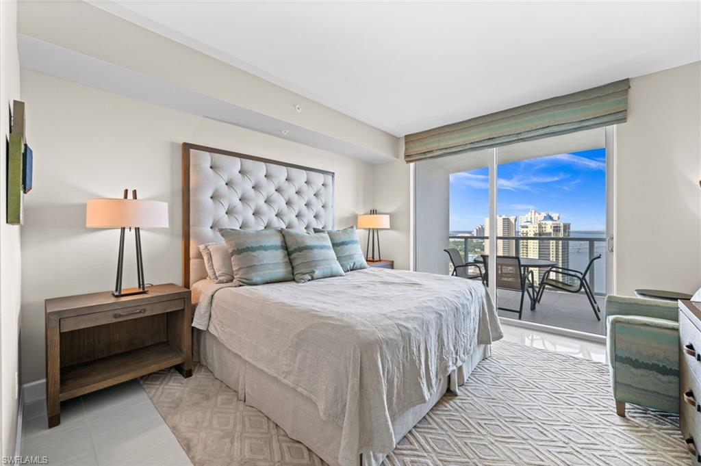 Bedroom with tile patterned flooring, access to exterior, floor to ceiling windows, and a city view