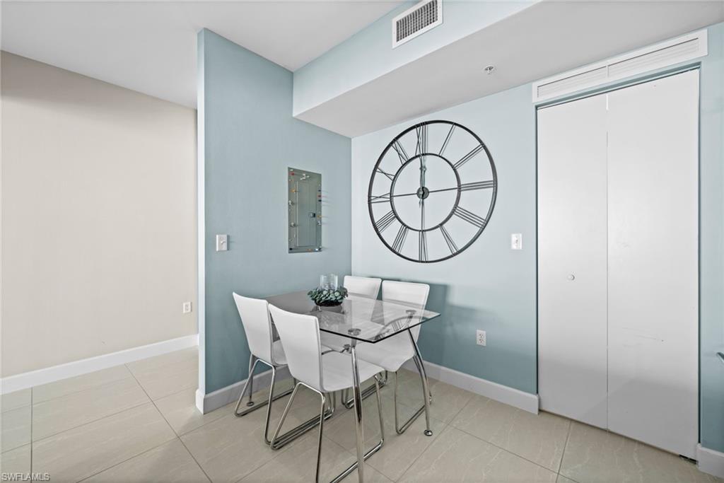 Dining area featuring light tile patterned floors and electric panel