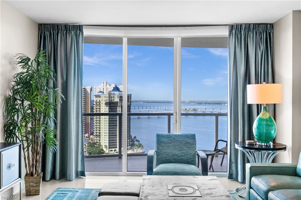 Living room with floor to ceiling windows and a water view