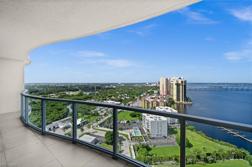 Balcony featuring a water view and a view of city