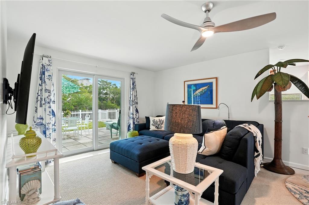 Living area featuring carpet floors and ceiling fan