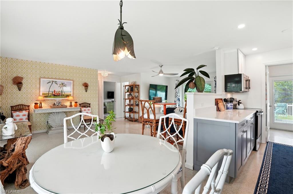 Dining space featuring wallpapered walls, recessed lighting, and ceiling fan