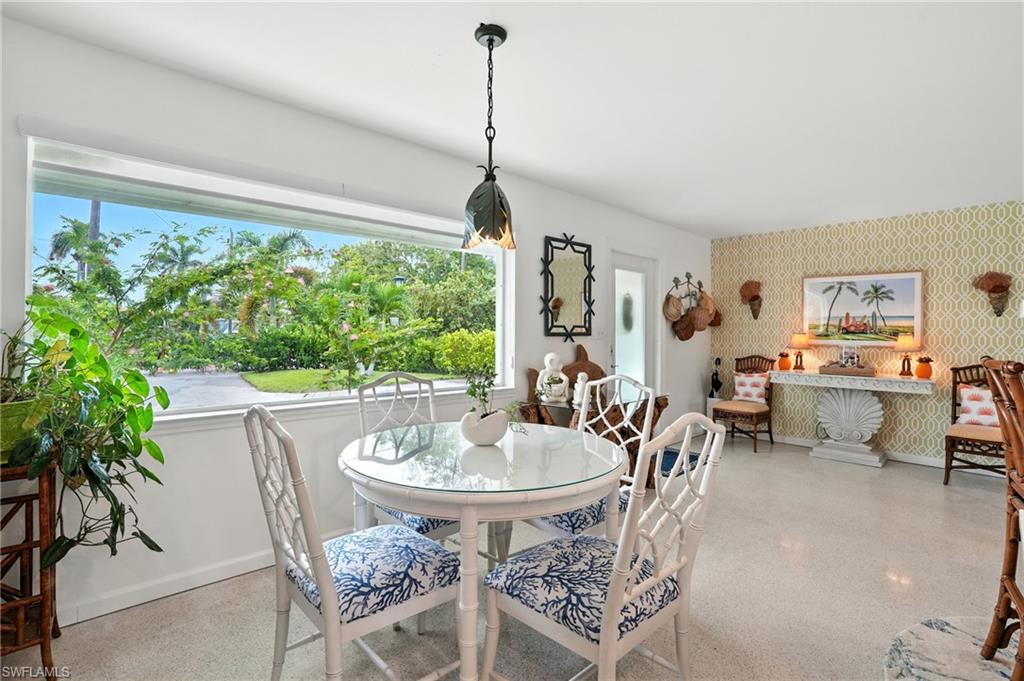 Dining space with wallpapered walls and baseboards