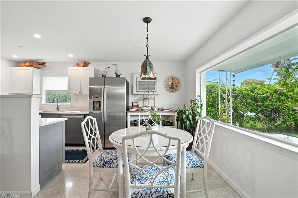 Dining space featuring recessed lighting and dark aggregate flooring