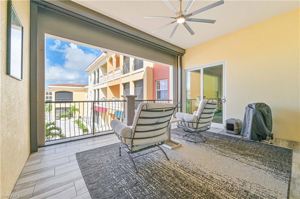 Sunroom / solarium with ceiling fan and a patio area