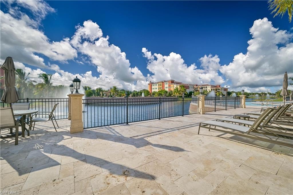 Community pool with a patio area and a community hot tub