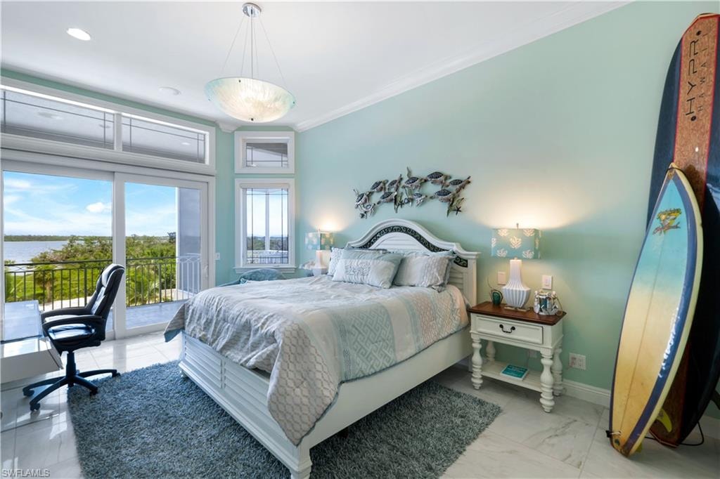Bedroom with access to exterior, crown molding, recessed lighting, and a water view