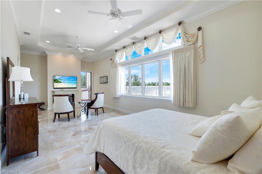 Bedroom featuring crown molding, a raised ceiling, recessed lighting, and ceiling fan