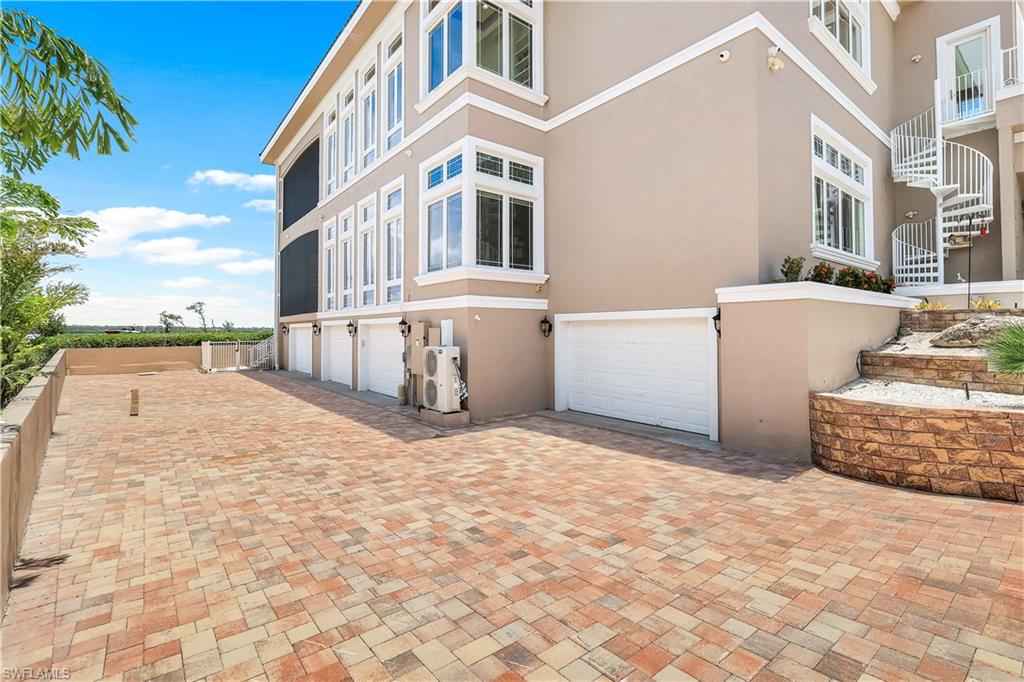View of garage entry on the left side of the house.  Garage doors are also on the right side of the house