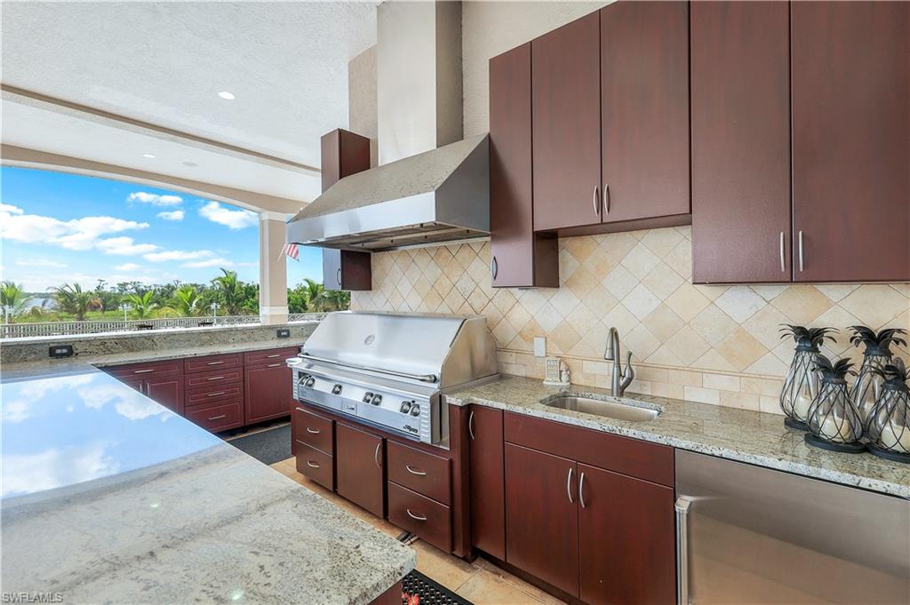 View of patio / terrace with exterior kitchen featuring a natural gas grill and plenty of cabinetry