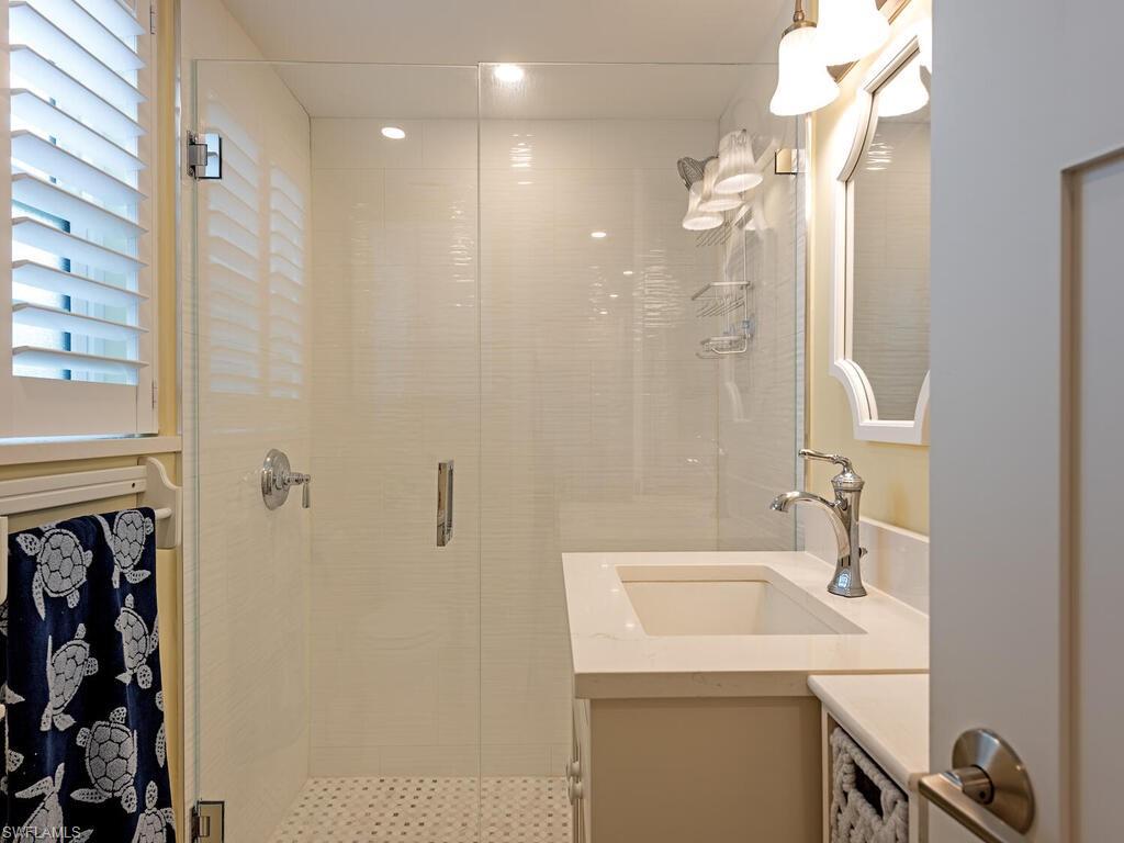 Full bathroom features updated shower and vanity.