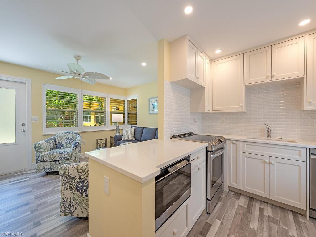The peninsula countertop offers an inviting space for guests to mingle and gather.
