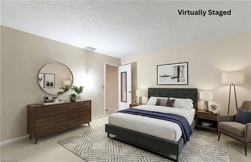 Bedroom with light carpet and baseboards