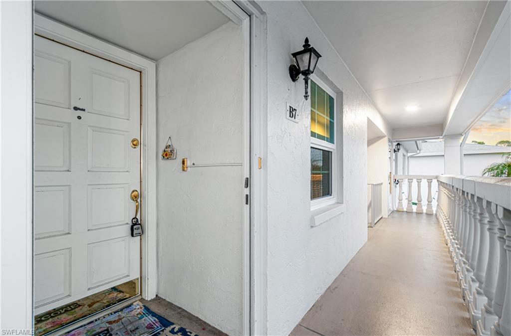 Doorway to property featuring stucco siding