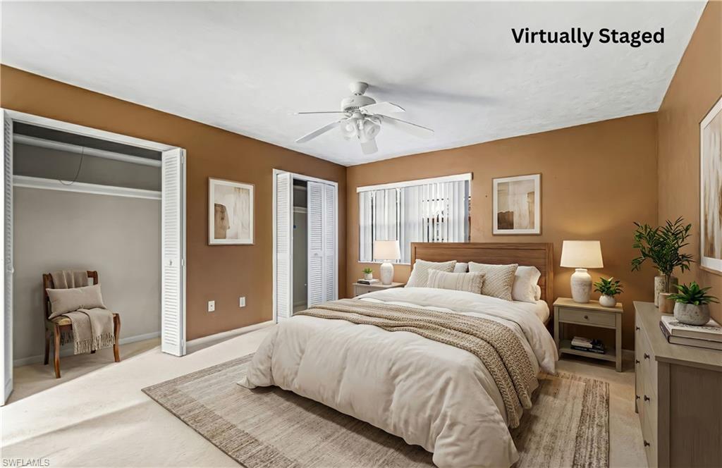 Bedroom with multiple closets, carpet, and a ceiling fan