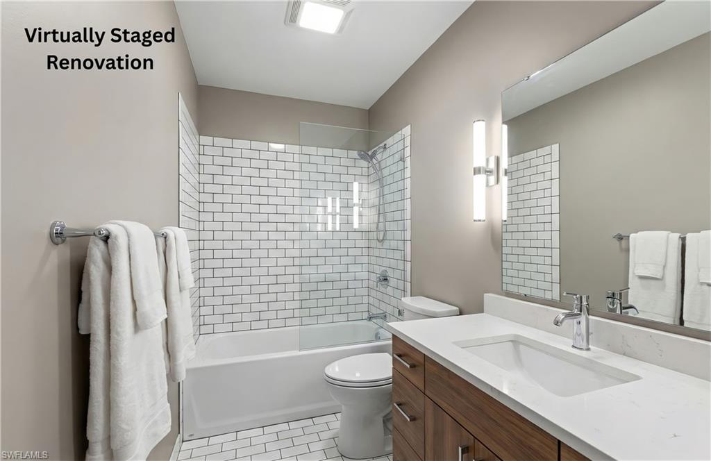 Bathroom with bathing tub / shower combination, vanity, and light tile patterned floors