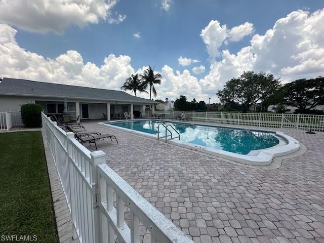 Community pool with a patio