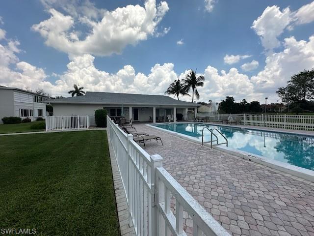 Community pool with a patio