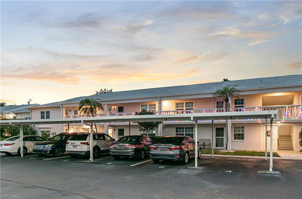 Property at dusk featuring covered parking