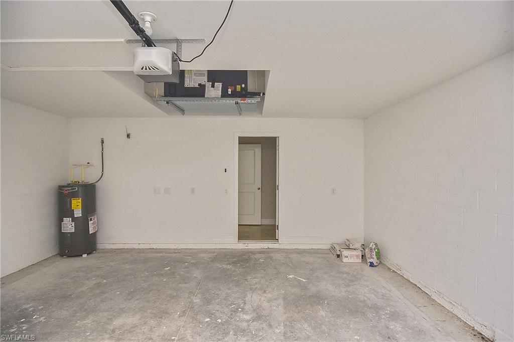 Garage with electric water heater and a garage door opener