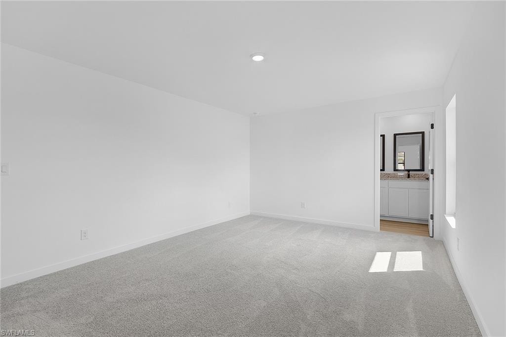 Unfurnished room featuring light colored carpet and recessed lighting