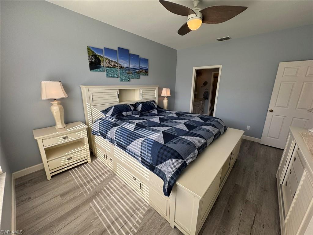 Bedroom featuring hardwood / wood-style floors and ceiling fan