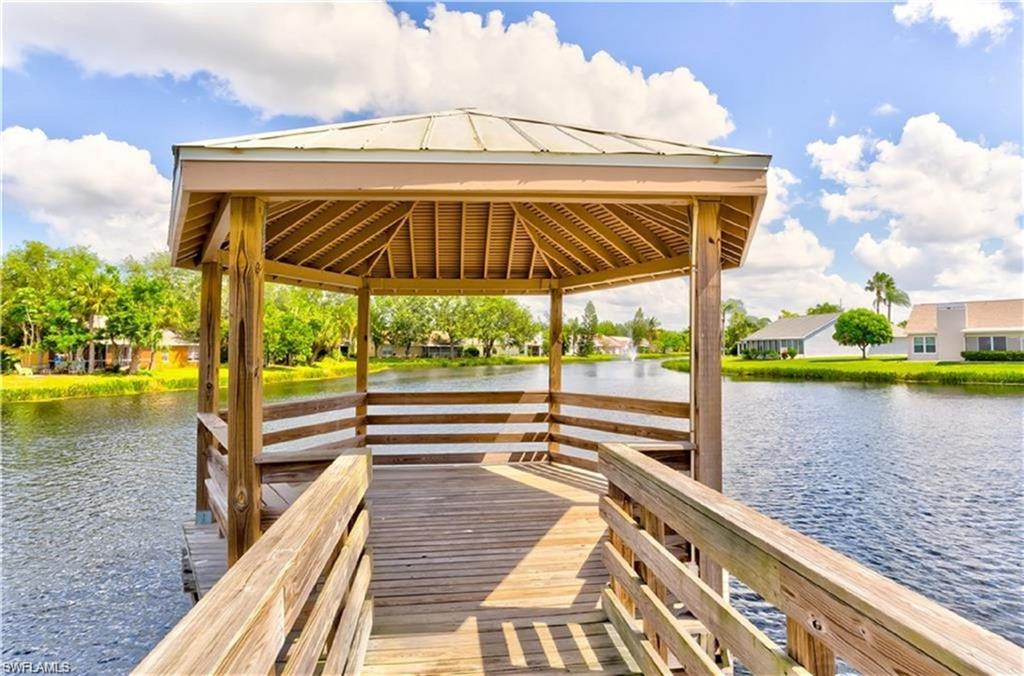 View of dock featuring a gazebo and a water view