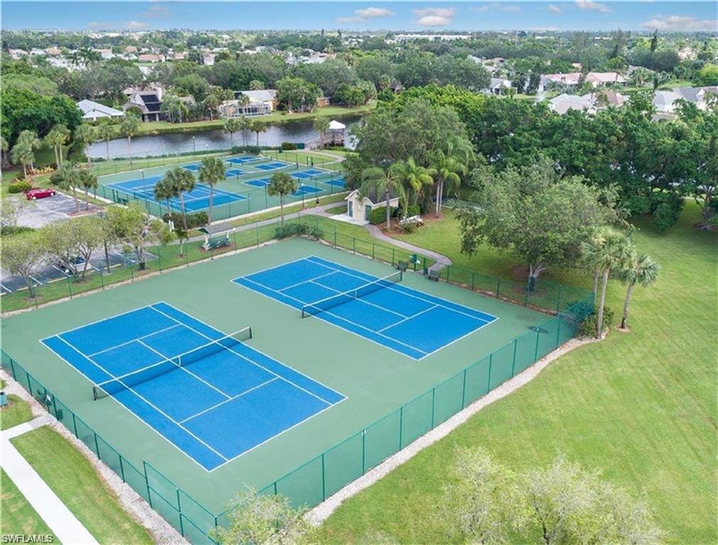 Birds eye view of property with a water view