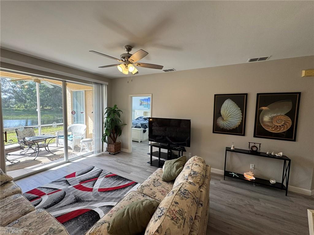 Living room with hardwood / wood-style floors and ceiling fan