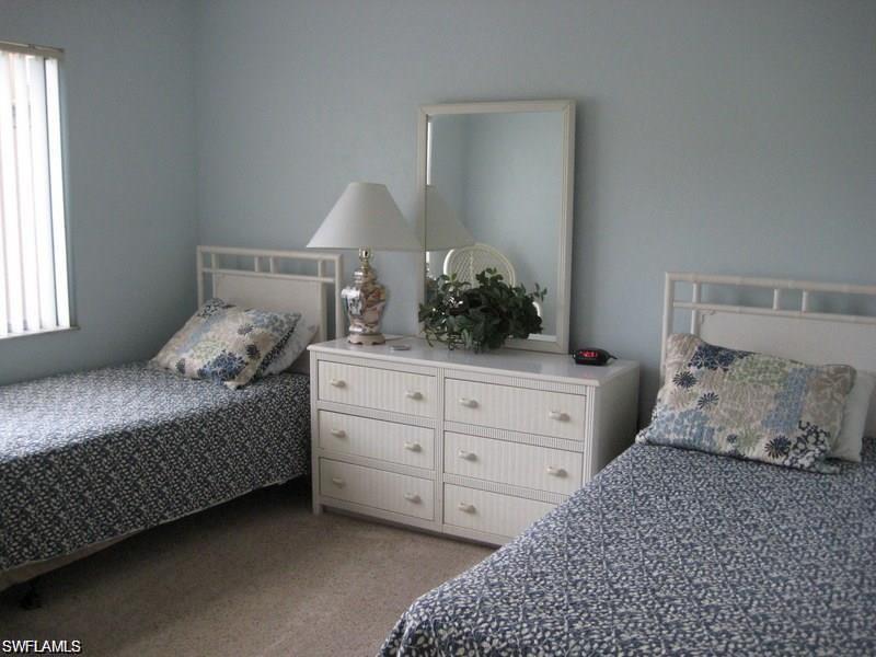 Bedroom featuring light colored carpet