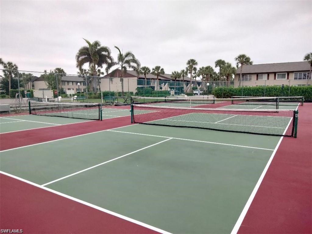 View of tennis court with community basketball court and a residential view