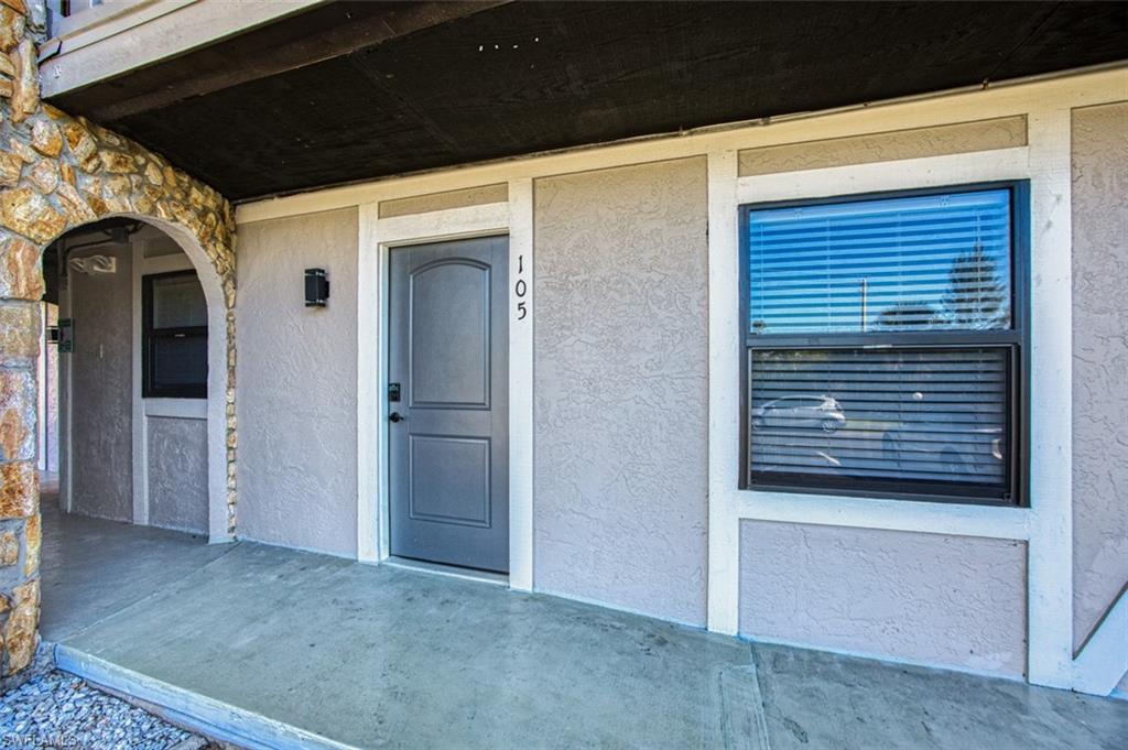 View of exterior entry with stucco siding