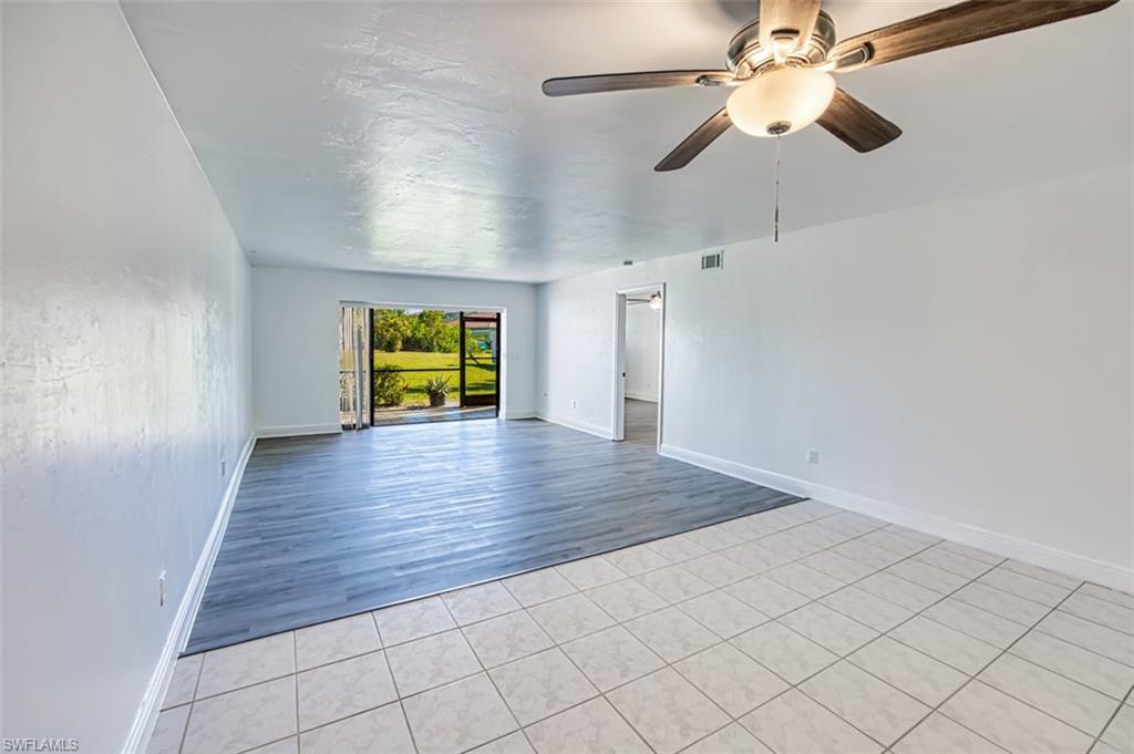 Spare room with light tile patterned flooring and ceiling fan