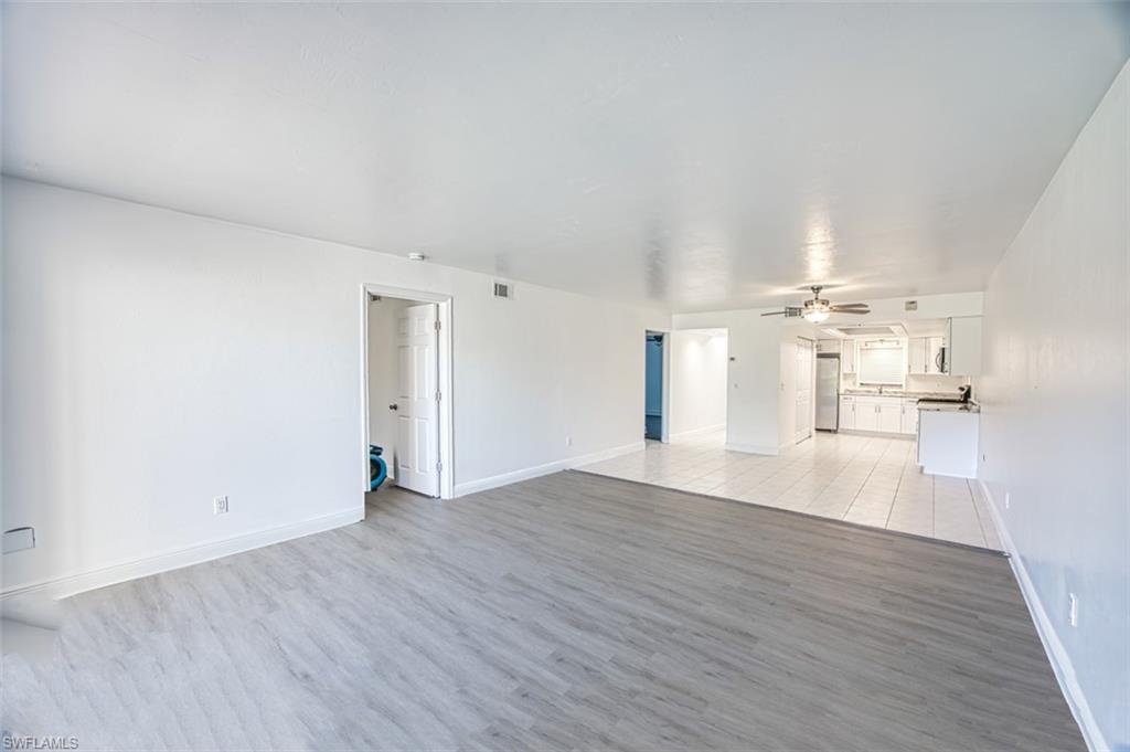 Unfurnished living room with light wood finished floors and a ceiling fan