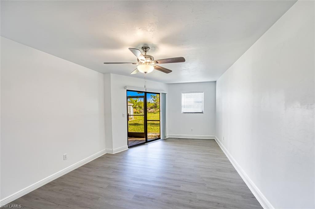 Empty room with light wood-type flooring and ceiling fan