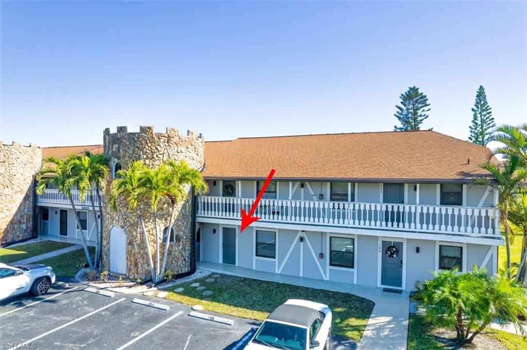 View of property with uncovered parking